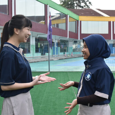 Two girls are talking about the holistic education in Malaysia.